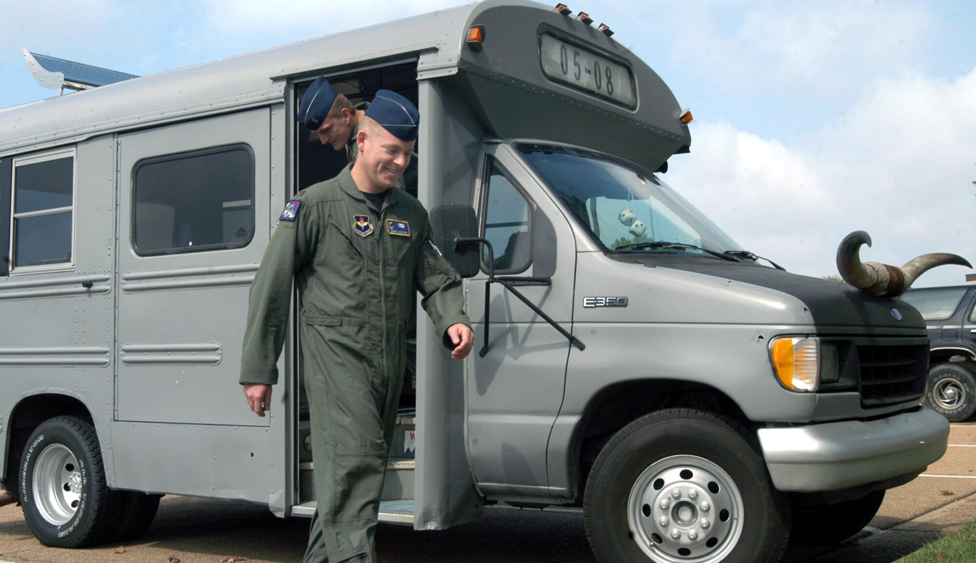 COLUMBUS AIR FORCE BASE, Miss. -- Second Lt. Virgil Watson steps off his class bus.  Student pilots of a specialized undergraduate pilot training class ride the bus to and from class, downtown for lunch and on weekend outings.  The students pooled their money together to buy the bus to emphasize class cohesiveness.  (U.S. Air Force photo by Airman Alexis Lloyd)
