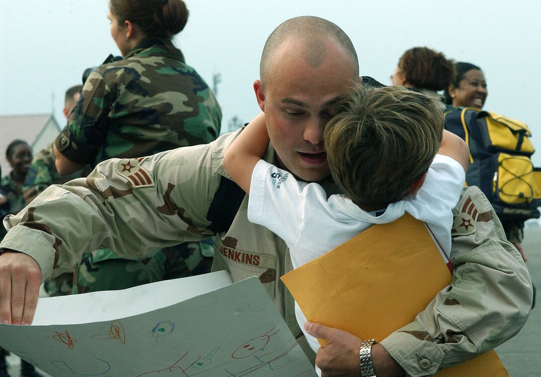 YOKOTA AIR BASE, Japan -- Senior Airman Frank Jenkins is welcomed home from an Operation Enduring Freedom deployment by his son, Ethan.  About 300 people welcomed back nearly 90 deployed Airmen at a Sept. 2 ceremony here.  Airman Jenkins is assigned to the 374th Civil Engineer Squadron.  (U.S. Air Force photo by Staff Sgt. Karen J. Tomasik)