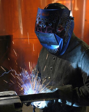 NELLIS AIR FORCE BASE, Nev. -- Staff Sergeant Welby Torres welds pieces of metal together to fabricate engine parts here recently. Sergeant Torres is a vehicle management craftsman assigned to the 99th Logistic Readiness Squadron.  (U.S. Air Force photo by Staff Sgt. Chris Flahive)