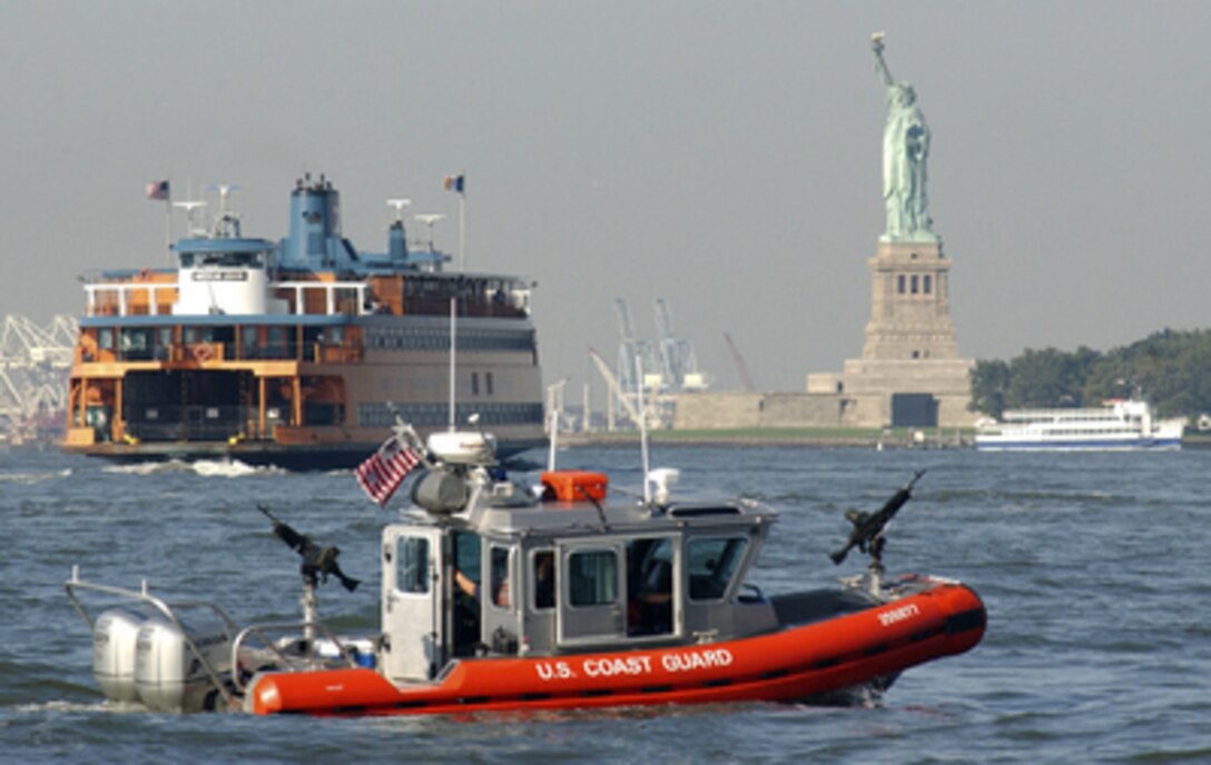 A 25-foot Defender-class security boat from Coast Guard Maritime Safety and Security Team 91106 keeps an eye on passenger vessels and high profile landmarks as it patrols New York Harbor on Sept. 1, 2004. The U.S. Coast Guard is leading the multi-agency waterside security effort around Manhattan Island during the Republican National Convention. 