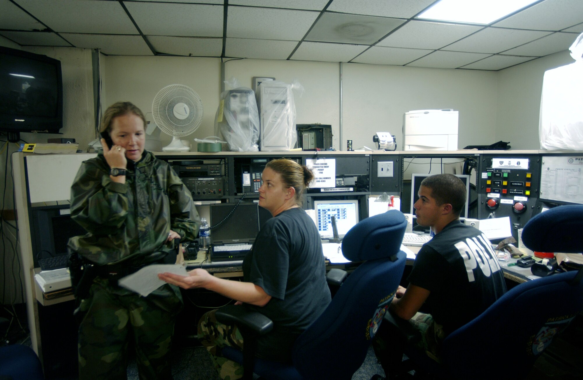 PATRICK AIR FORCE BASE, Fla. -- Capt. Cheryl Morgan (left) coordinates recovery operations from the base fire department control center here Sept. 5, after Hurricane Frances hit the base and surrounding communities.  Captain Morgan, an operations officer with the 45th Security Forces Squadron, is part of the 45th Hurricane Recovery Team.  The team is responsible for securing and establishing the base's operational readiness once a storm moves throughthe area.  (U.S. Air Force photo by Master Sgt. Efrain Gonzalez)