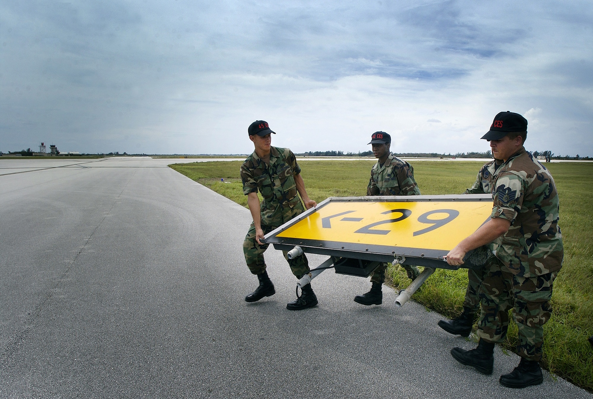 PATRICK AIR FORCE BASE, Fla. -- Members of the 45th Hurricane Recovery Team secure debris scattered on the base's runway in an effort to establish flight operations Sept. 6 after Hurricane Frances hit the base and the surrounding community.  (U.S. Air Force photo by Master Sgt. Efrain Gonzalez)