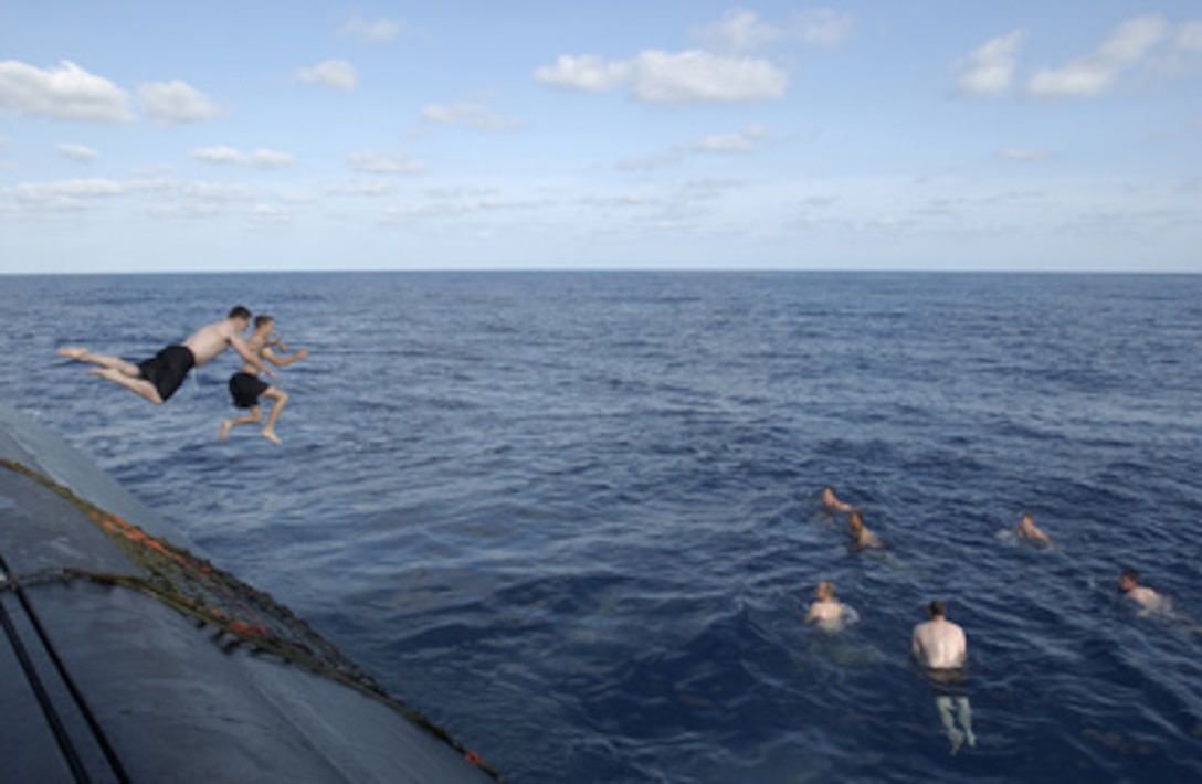 Crewmembers of the USS Portsmouth (SSN 707) leap into the waters of the Pacific Ocean during a swim call on Aug. 15, 2004. Portsmouth is a Los Angeles Class Fast Attack nuclear-powered submarine on a final cruise to Norfolk, Va., where it is scheduled for decommissioning in October of 2005. 