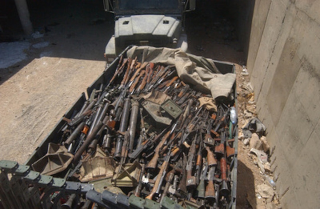 A U.S. Marine 7-ton truck stands full of captured and recovered weapons in An Najaf, Iraq, on Sept. 3, 2004. The large quantity of weapons stockpiled by the Muqtada Militia was found by the 11th Marine Expeditionary Unit Explosive Ordnance Disposal teams. 