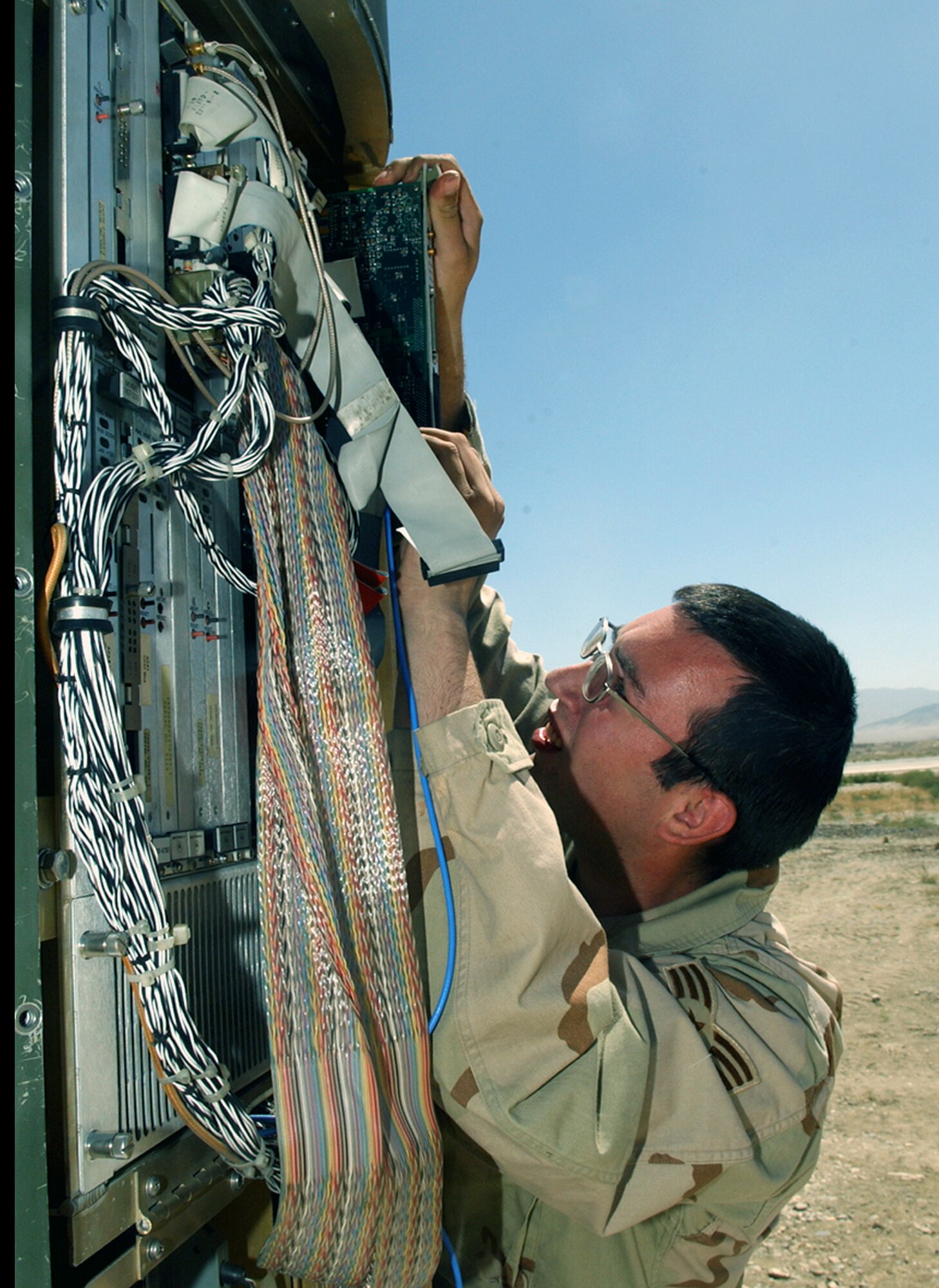 BAGRAM AIR BASE, Afghanistan -- Senior Airman Wade Evans replaces a circuit card in the Mobile Radar Navigation-25 tactical radar system.  The system, built in 1998, is one of three in the world.  (U.S. Air Force photo by Master Sgt. Andrew Gates)
