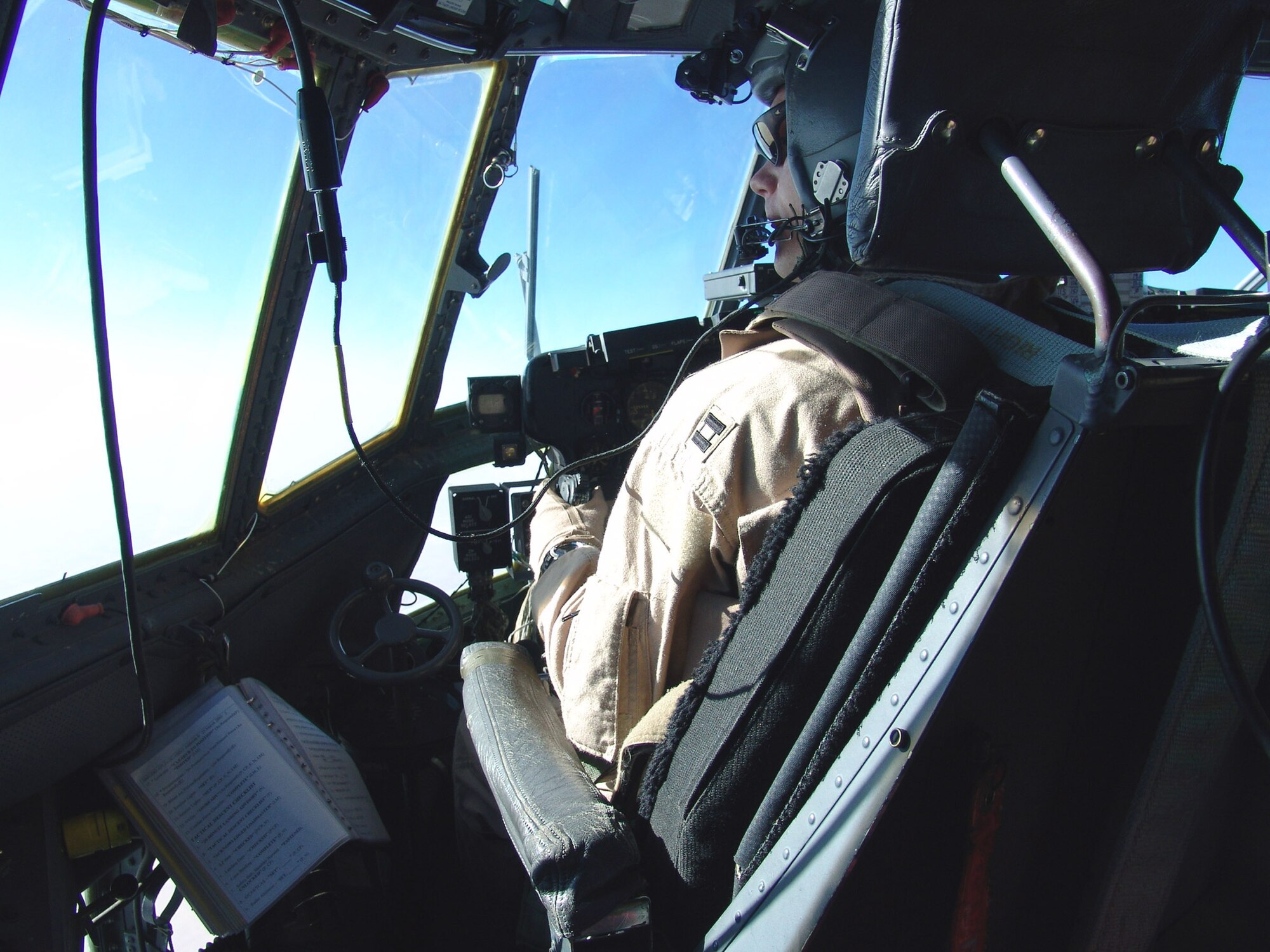 SOUTHWEST ASIA -- Capt. Todd Linton scans the ground for threats during a flight Sept. 12.  He is a C-130 Hercules pilot for the 746th Expeditionary Airlift Squadron and is deployed from Ramstein Air Base, Germany.  (U.S. Air Force photo by Capt. Denise Boyd)