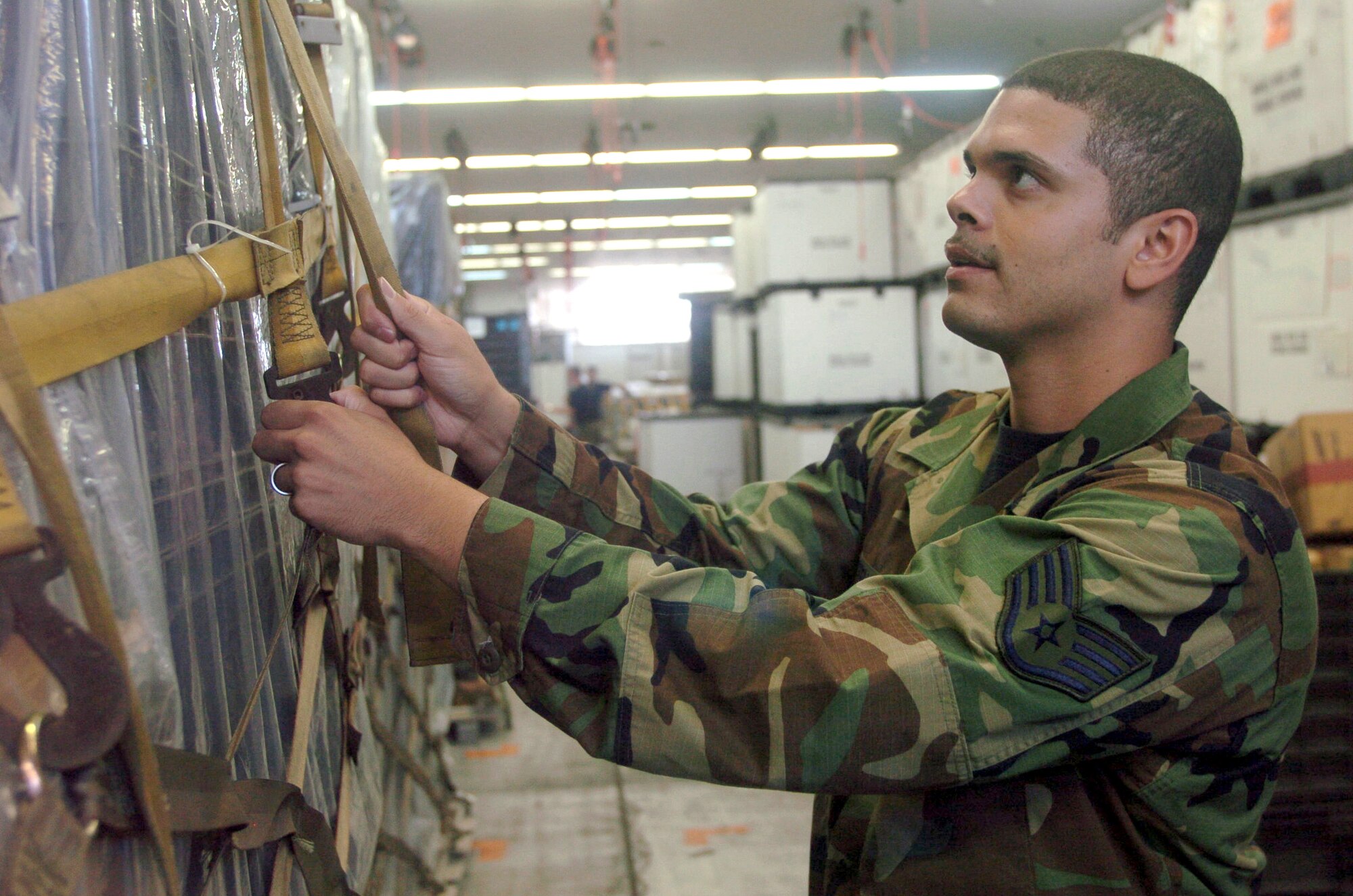 YOKOTA AIR BASE, Japan -- Staff Sgt. Ken Abernathy checks the straps on a cargo pallet during an inspection at a warehouse here.  Sergeant Abernathy and other medical logistics technicians from the 374th Medical Group handle about $24 million dollars worth of medical war reserve materiel supplies and equipment here for military combat and contingency operations.  (U.S. Air Force photo by Master Sgt. Val Gempis)