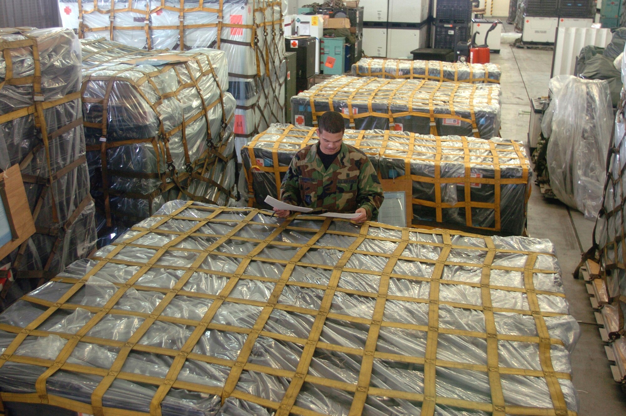 YOKOTA AIR BASE, Japan -- Staff Sgt. Ken Abernathy checks the inventory sheet for expeditionary medical support pallets during an inspection at a warehouse here.  An EMEDS kit is a modern field hospital that can fill as many as 30 cargo pallets.  The kit contains more than 1,100 equipment items.  Sergeant Abernathy and other medical logistics technicians from the 374th Medical Group handle about $24 million dollars worth of medical war reserve materiel supplies and equipment here for military combat and contingency operations.  (U.S. Air Force photo by Master Sgt. Val Gempis)