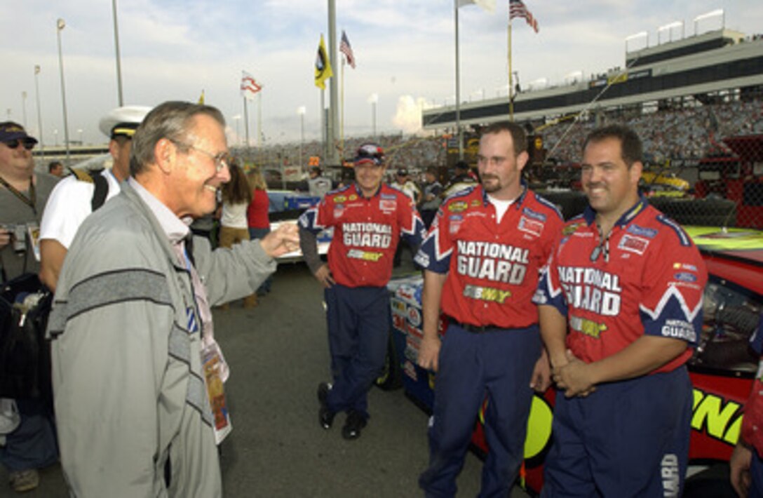 Secretary of Defense Donald H. Rumsfeld meets with the pit crew for the National Guard car driven by Greg Biffle prior to the start of the Chevy Rock & Roll 400 NASCAR Nextel Cup Series race at Richmond International Raceway, Va., on Sept 11, 2004. Rumsfeld was at the race to thank the fans for their support of the military and to visit with the drivers and crews. 