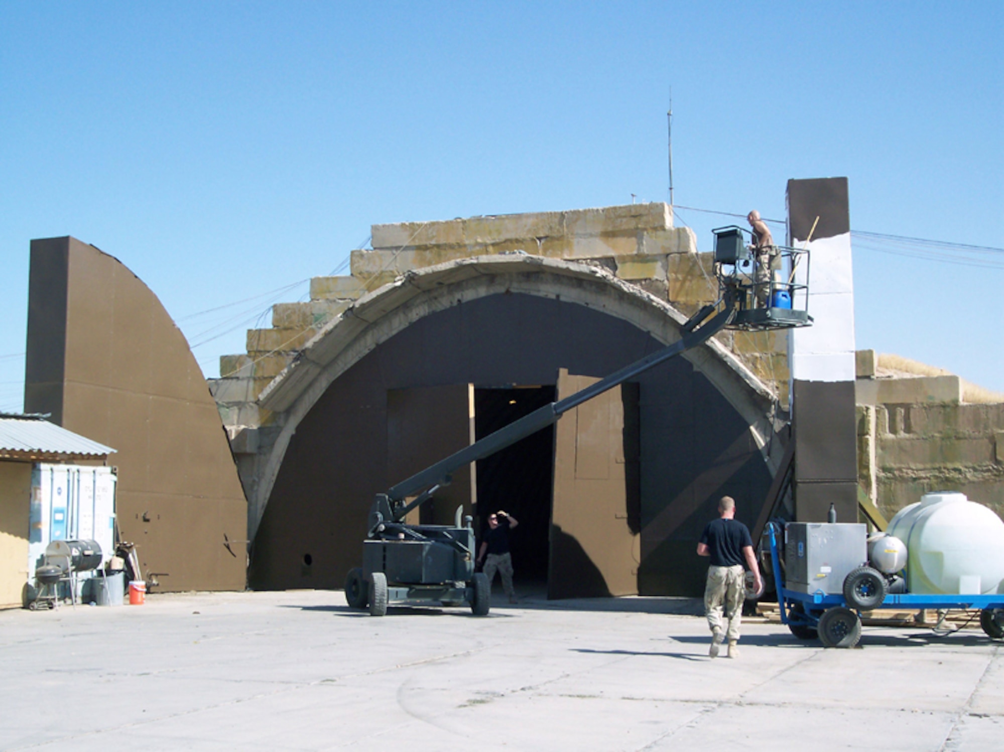 KARSHI-KHANABAD AIR BASE, Uzbekistan -- Airmen from the 41st Expeditionary Electronic Combat Squadron are turning an old hardened aircraft shelter into a new home.  The former Soviet-era shelter had been used as a storage area and had been deteriorating for some time.  (U.S. Air Force photo by Tech. Sgt. Matthew Vera)