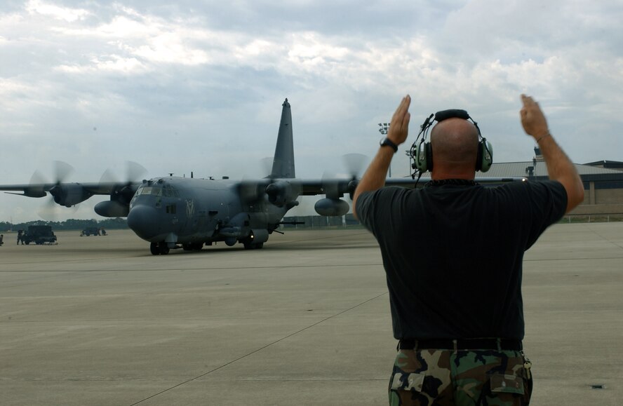 HURLBURT FIELD, Fla. -- Tech. Sgt. Paul McAllister marshals an AC-130U gunship Sept. 13.  The plane was evacuating because of Hurricane Ivan.  (U.S. Air Force photo by Airman 1st Class Kimberly Gilligan)