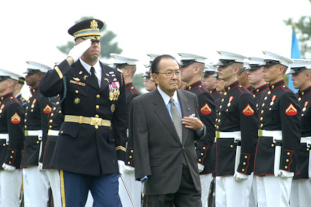 Sen. Daniel K. Inouye, (D) of Hawaii, inspects the joint services honor guard assembled on the Pentagon parade field during the observance of National POW/MIA Recognition Day on Sept. 14, 2004. Inouye, the guest of honor for the ceremony and the featured speaker, was initially barred, because of his Japanese ancestry, from serving in the armed forces during World War II, but later distinguished himself in combat on the Italian peninsula. Losing his right hand to a German grenade and sustaining multiple gunshot wounds, he displayed uncommon valor in leading his troops and was awarded the Medal of Honor for his courage and determination under fire. Escorting Inouye is the Commander of Troops for the ceremony Col. Charles Taylor, U.S. Army. 