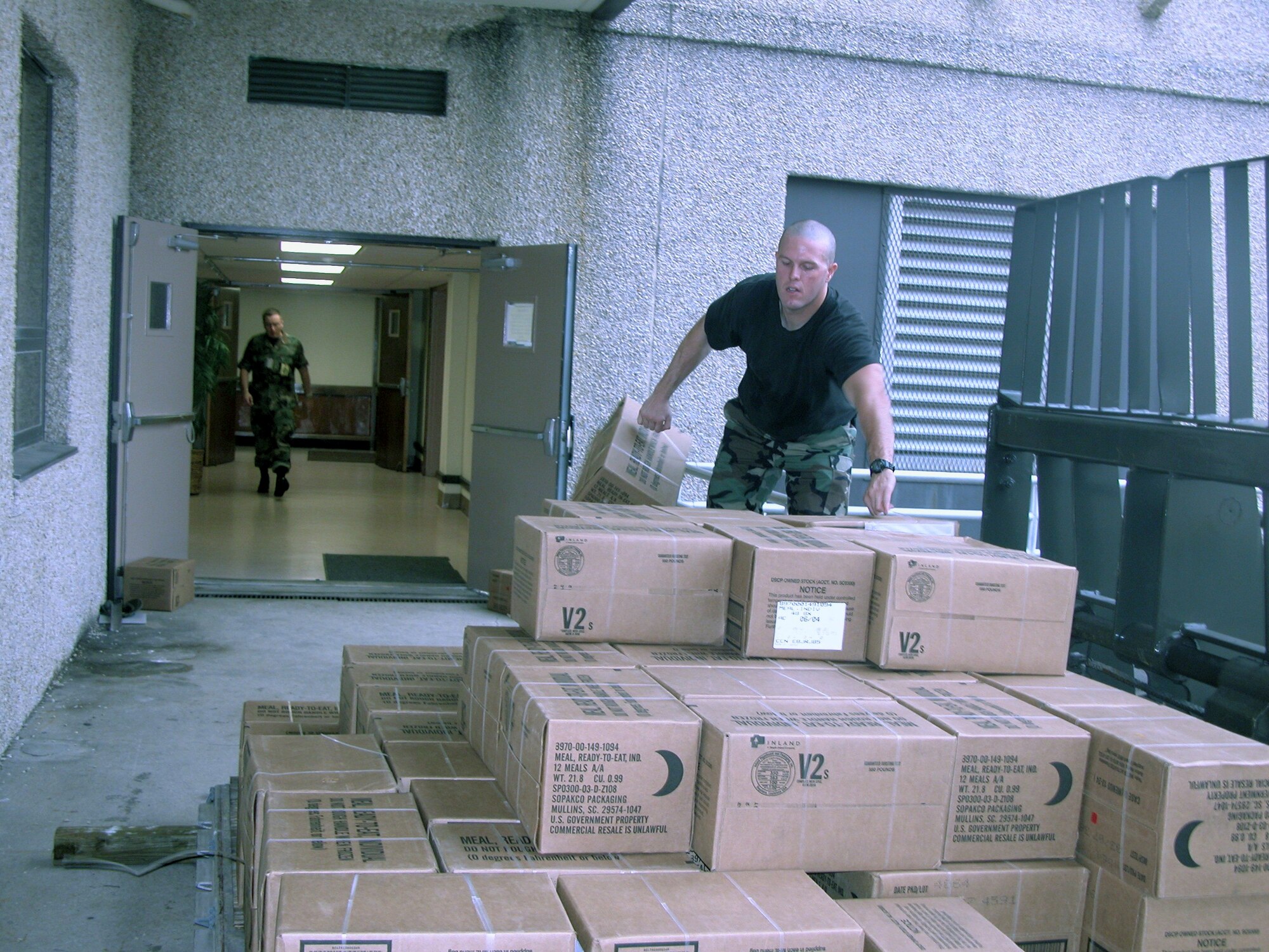EGLIN AIR FORCE BASE, Fla. -- Airmen from the 96th Services Squadron stock the shelter in the base headquarters building here with packaged meals.  Forecasters predict Hurricane Ivan will hit the base early Sept. 16.  (U.S. Air Force photo by Lois A. Walsh)