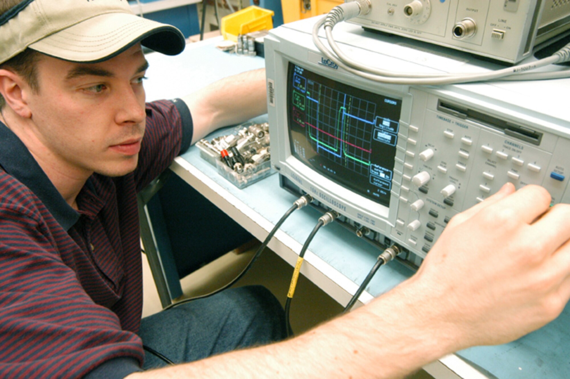 ROBINS AIR FORCE BASE, Ga. -- Greg Bookhardt calibrates a Lecroy digital oscilloscope which is used to test equipment on aircraft and ground radar systems.  During the next three years, the Air Force will reduce the number of oscilloscope models from 190 to three.  Mr. Bookhardt is a precision measurement equipment laboratory technician here.  (U.S. Air Force photo by Sue Sapp)