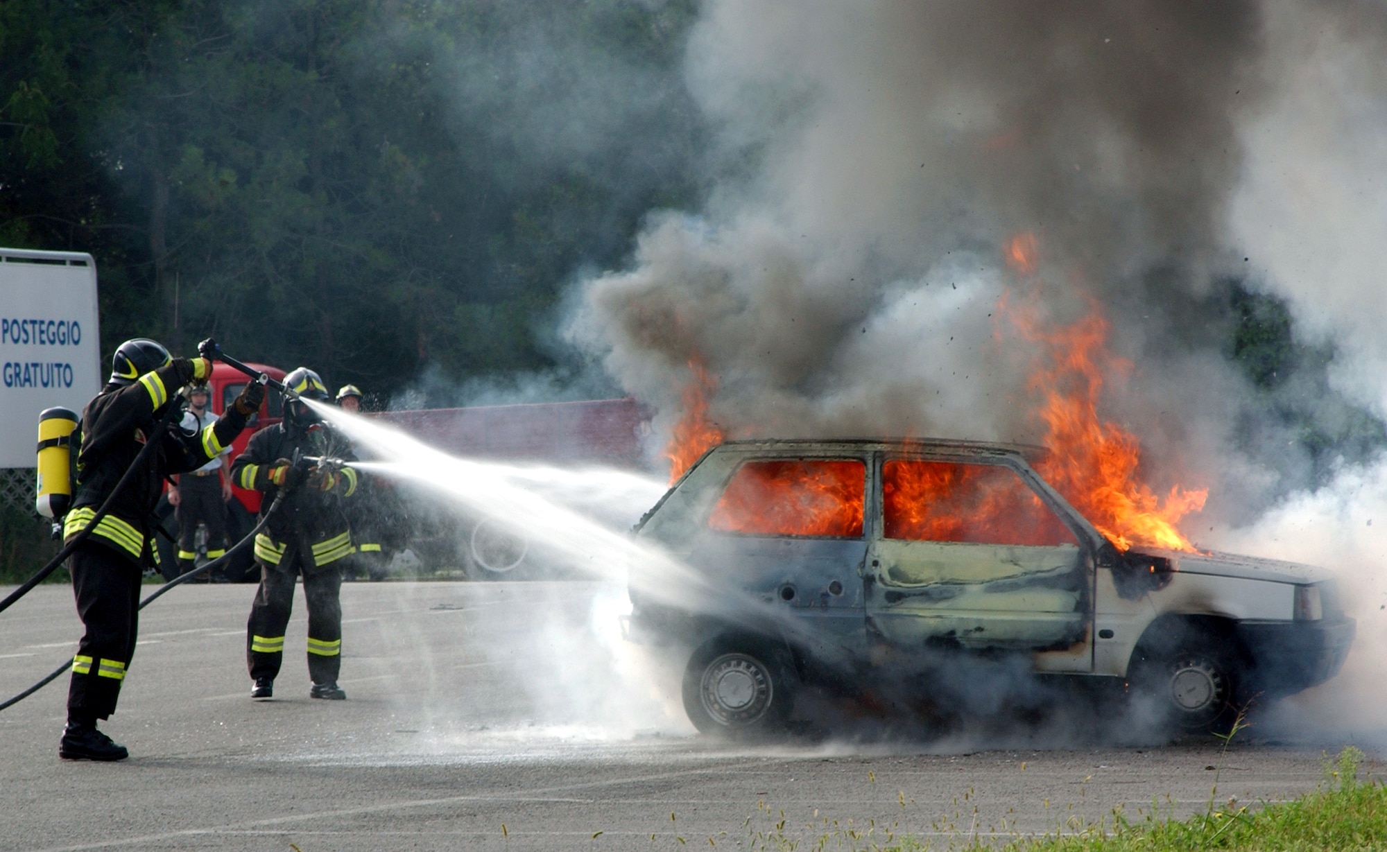 ROVEREDO IN PIANO, Italy -- Firefighters extinguish a car fire during a mass casualty exercise held in a shopping district here Sept. 13.  The exercise, which simulated a terrorist attack, involved Airmen from nearby Aviano Air Base and Italian authorities, and allowed them to practice and strengthen their emergency response skills together.  (U.S. Air Force photo by Senior Airman Nichole Adamowicz)