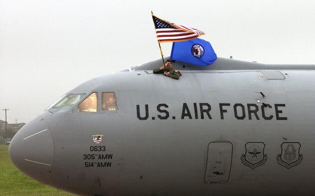 MCGUIRE AIR FORCE BASE, N.J. -- Senior Master Sgt. Thomas Kenny displays the American and 6th Airlift Squadron flags aboard the final C-141B Starlifter to leave here Sept. 16.  The C-141 is heading to permanent storage at Davis-Monthan Air Force Base, Ariz.  Sergeant Kenny is assigned to the 6th AS.  (U.S. Air Force photo by Scott H. Spitzer)