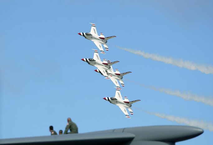 ANDERSEN AIR FORCE BASE, Guam -- The United States Air Force Demonstration Team "Thunderbirds" perform their "photo pass" flying over the top of a C-5 Galaxy here Sept. 12.  The Thunderbird performance here was the first time in 10 years.  Andersen's open house air show drew a crowd of more than 20,000.  (U.S. Air Force photo by Staff Sgt. Bennie J. Davis III)