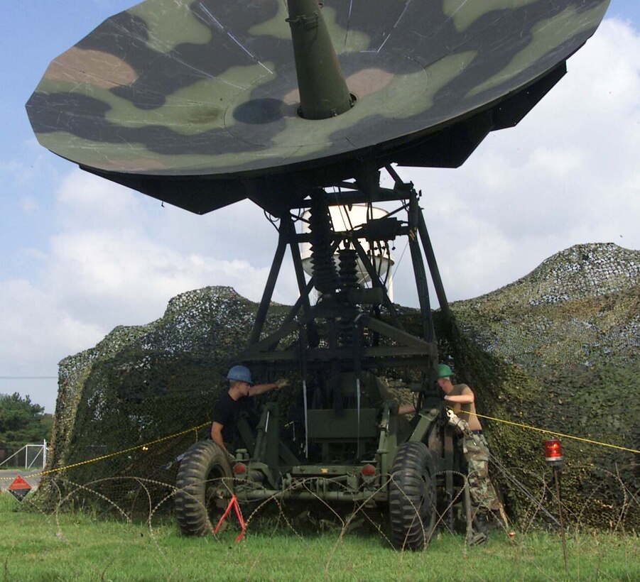 GWANGJU AIR BASE, South Korea -- Senior Airmen Christopher Gremling and David McNally perform daily maintenance on a tactical satellite terminal here Sept. 8.   Both Airmen are satellite communications technicians assigned to Camp Humphreys, South Korea.  (U.S. Air Force photo by Staff Sgt. Steven R. Nabor) 