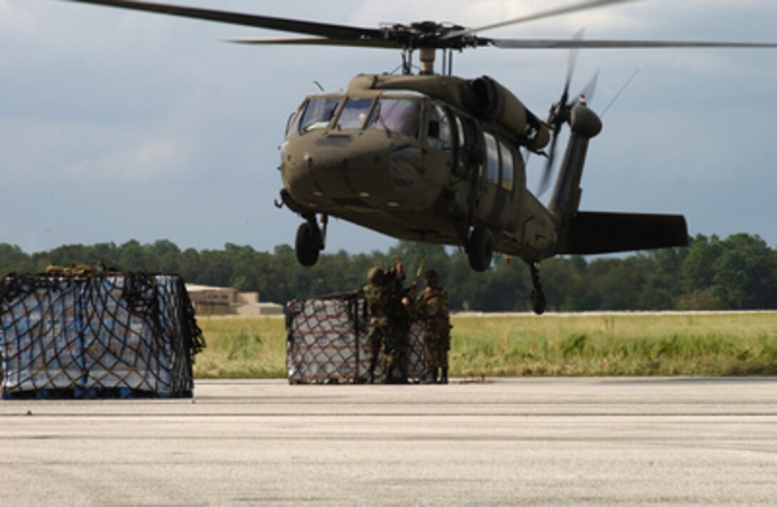 U.S. Army soldiers from a vertical replenishment team hook a sling load of water to a UH-60 Blackhawk helicopter for airlift from Lakeland Linder Airport, Fla., to distribution points around the state of Florida following Hurricane Frances on Sept. 9, 2004. The team is from the Florida National Guard, 53rd Combat Support Battalion and the Blackhawk is from the Alabama National Guard. 