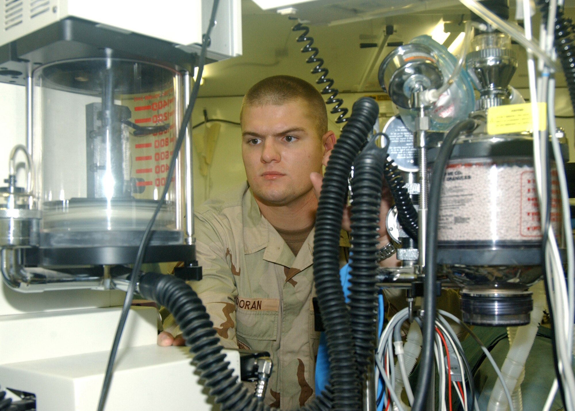 KIRKUK AIR BASE, Iraq -- Senior Airman Gary Doran tests the oxygen flow on a mobile anesthesia machine at the 506th Expeditionary Medical Squadron here Sept. 15.  Airman Doran is a forward-deployed biomedical equipment technician temporarily assigned to the Army's 354th Medical Logistics Company in Southwest Asia.  He travels to repair medical equipment throughout Southwest Asia.  Airman Doran is from the 375th Medical Support Squadron at Scott Air Force Base, Ill.  (U.S. Air Force photo by Staff Sgt. Marc Barnes)