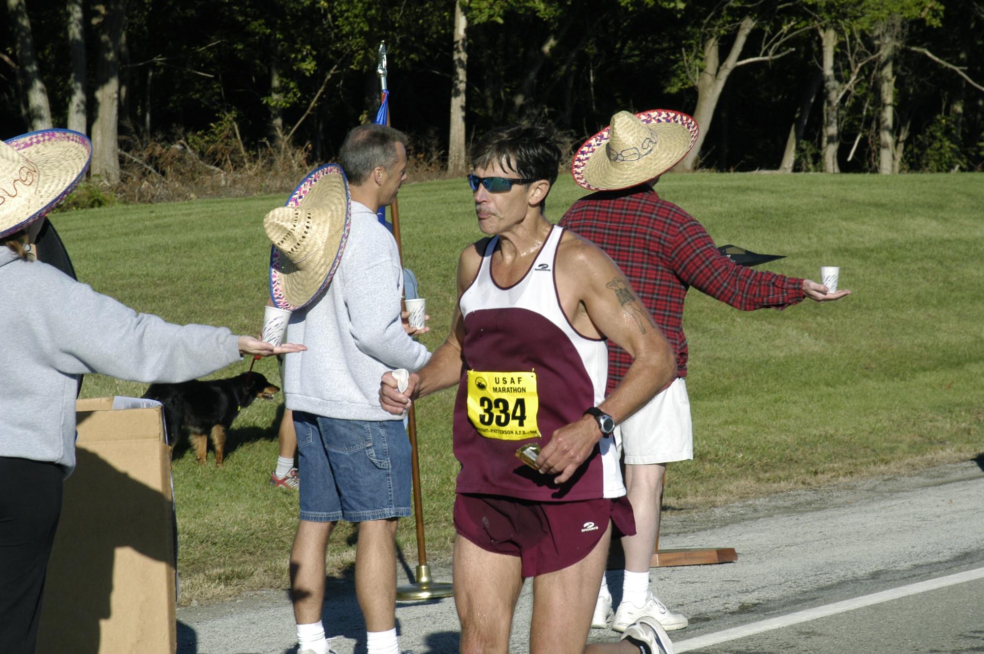 WRIGHT-PATTERSON AIR FORCE BASE, Ohio -- Daniel Ponder gets some water from the 19.5-mile refreshment station during his full marathon run at the 8th annual official Air Force Marathon here Sept. 18.  The refreshment stations were about every mile along the course and each organized with a theme.  Mr. Ponder is from Tinker Air Force Base, Okla.  (U.S. Air Force photo by 1st Lt. Adrianne Michele)