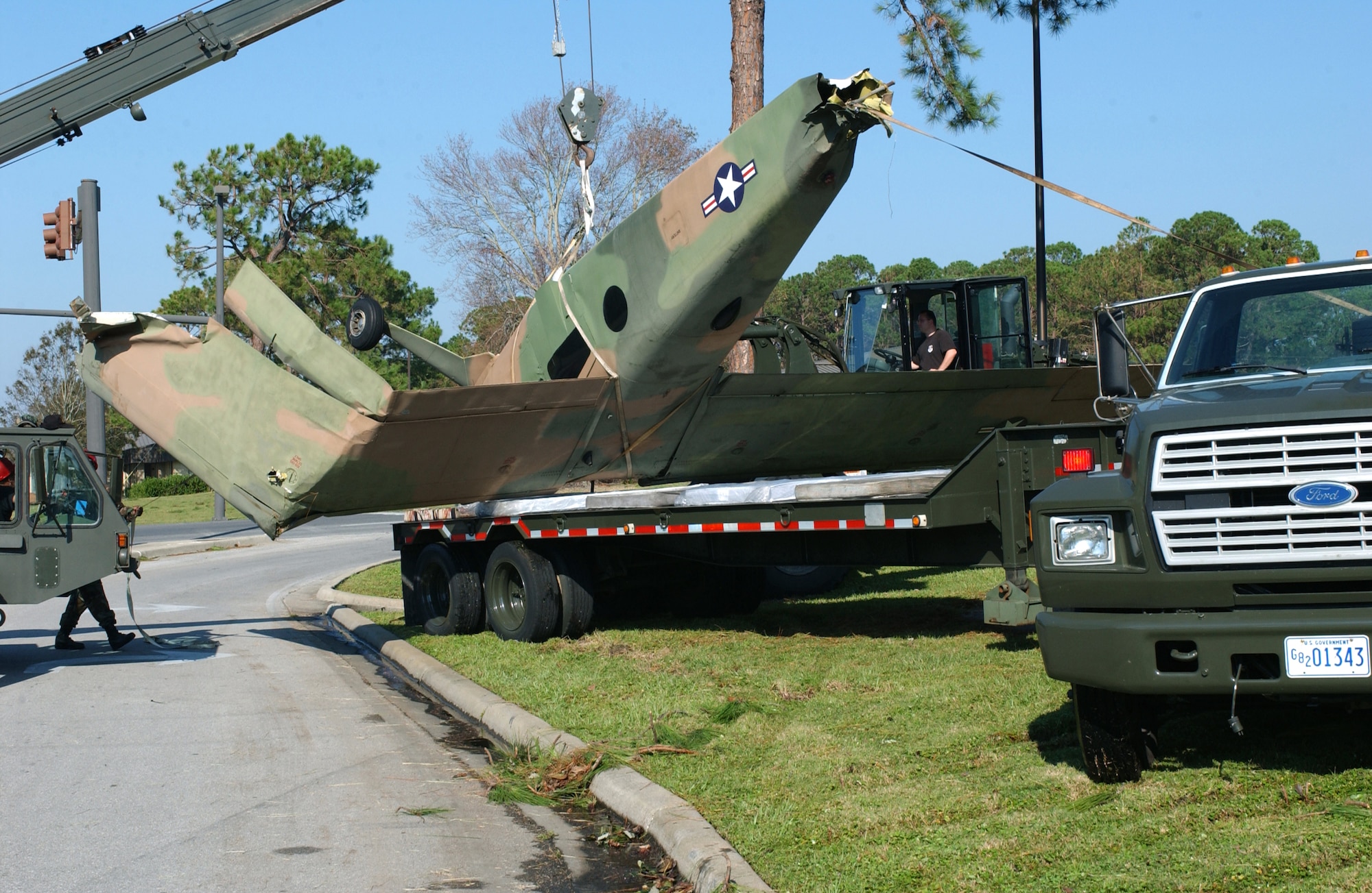 HURLBURT FIELD, Fla. -- One of the aircraft from a park display here is taken away after it was blown around by Hurricane Ivan on Sept. 16.  No one was injured, and base officials are still restoring operations.  (U.S. Air Force photo by Airman 1st Class Kimberly Gilligan)                