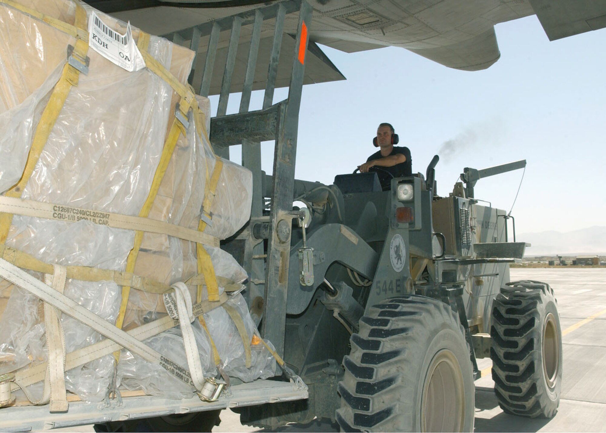 BAGRAM AIR BASE, Afghanistan -- Staff Sgt. Tim Wolberg unloads a pallet of supplies off a 517th Airlift Squadron C-130 Hercules from Elmendorf Air Force Base, Alaska.  He is an air transport technician with the 455th Expeditionary Logistics Readiness Squadron's air terminal operations center here and deployed from Pope AFB, N.C.  (U.S. Air Force photo by Staff Sgt. Jennifer Lindsey)