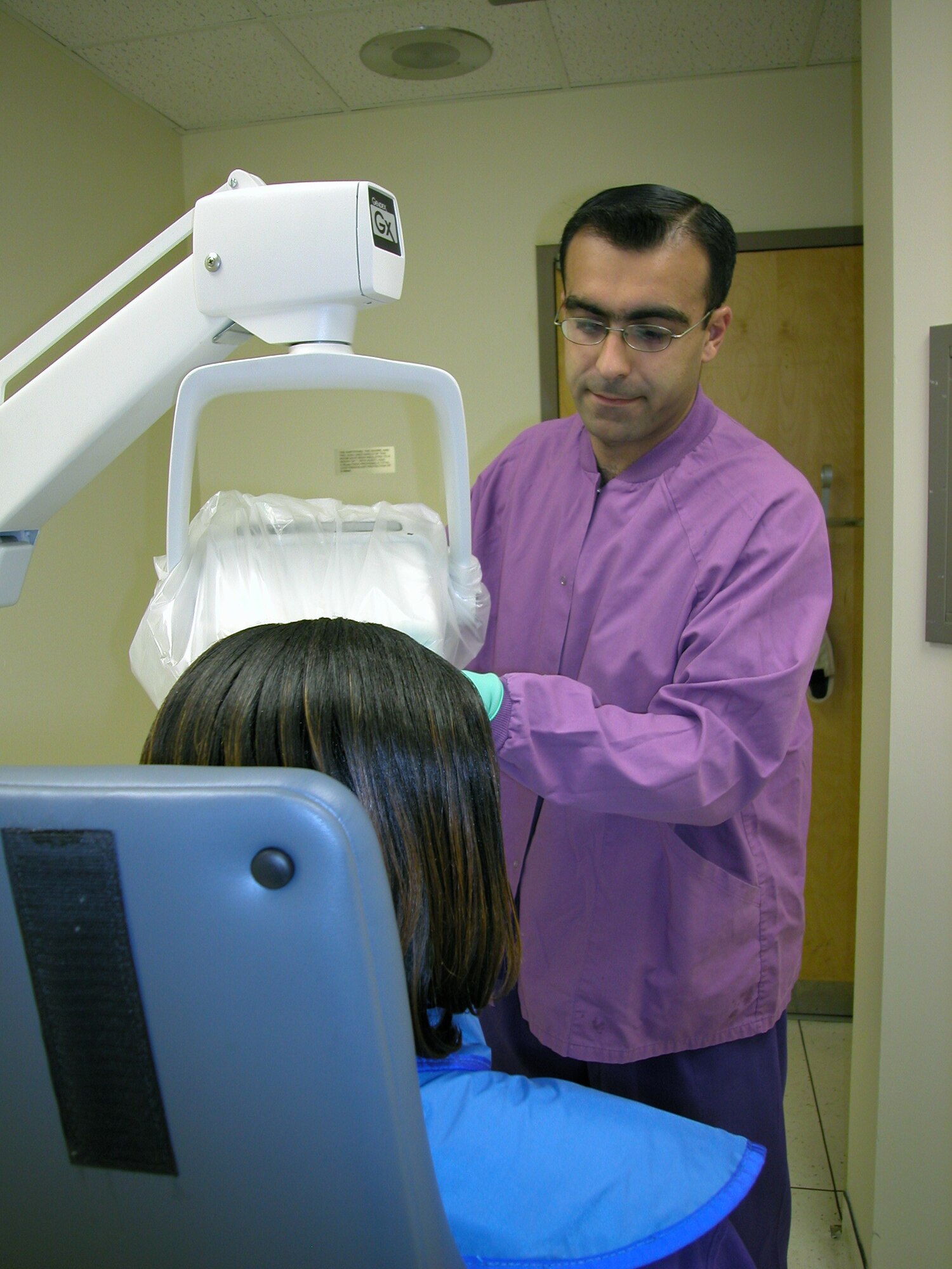 WRIGHT-PATTERSON AIR FORCE BASE, Ohio -- Airman 1st Class Mohammed Al Janabi prepares to take a dental X-ray.  Born in Iraq, he became a U.S. citizen during ceremonies held in the federal courthouse in nearby Dayton on Sept. 16.  He is a dental technician with the 74th Dental Squadron here.  (U.S. Air Force photo by Al Eakle)