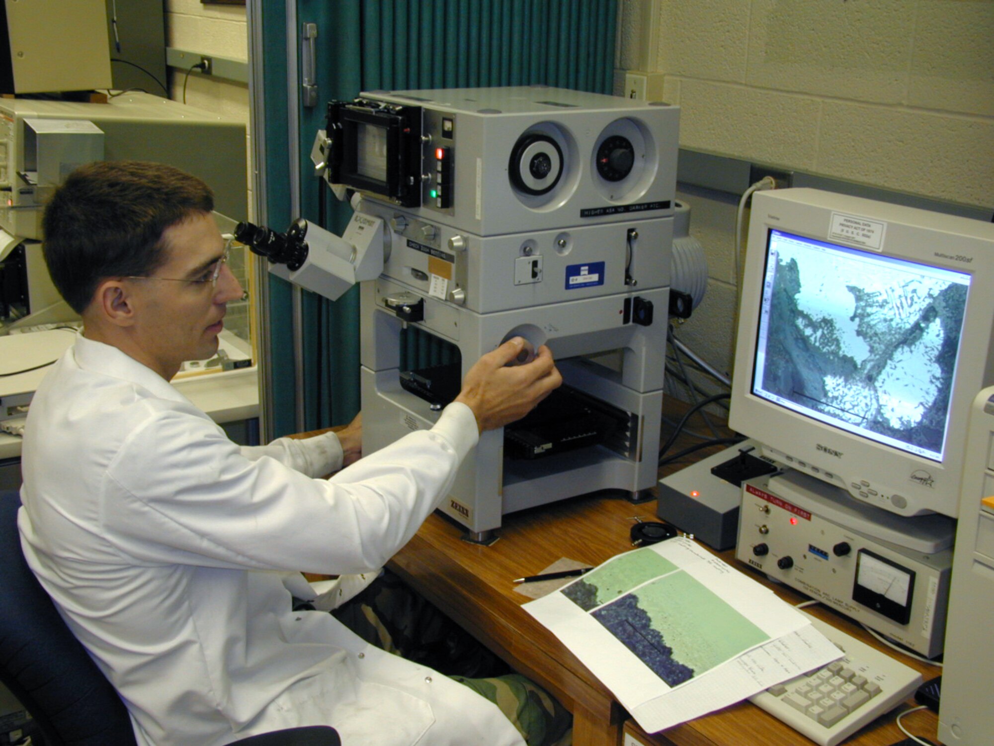 WRIGHT-PATTERSON AIR FORCE BASE, Ohio -- Second Lt. Nathan Dozier investigates corrosion on an aircraft component using an optical microscope.  Air Force Research Laboratory experts here will conduct investigations on C-5 Galaxy components using similar methods.  Lieutenant Dozier is with the materials integrity branch at AFRL's materials and manufacturing directorate.  (Courtesy photo)