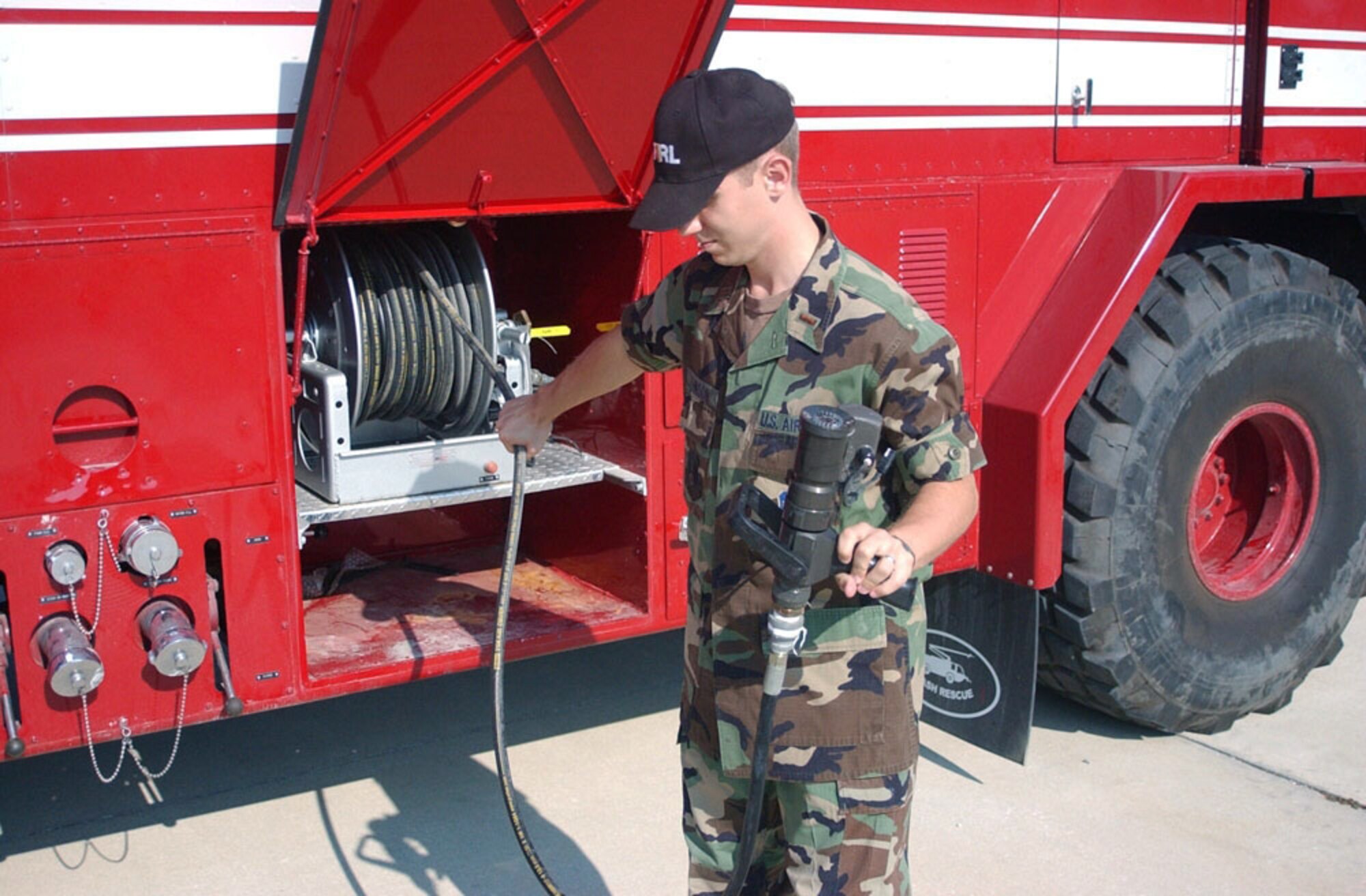 TYNDALL AIR FORCE BASE, Fla. -- Second Lt. Bob Johnson prepares the ultra-high pressure fire-extinguishing system for use.  He is the fire research group project officer here.  (Courtesy photo)