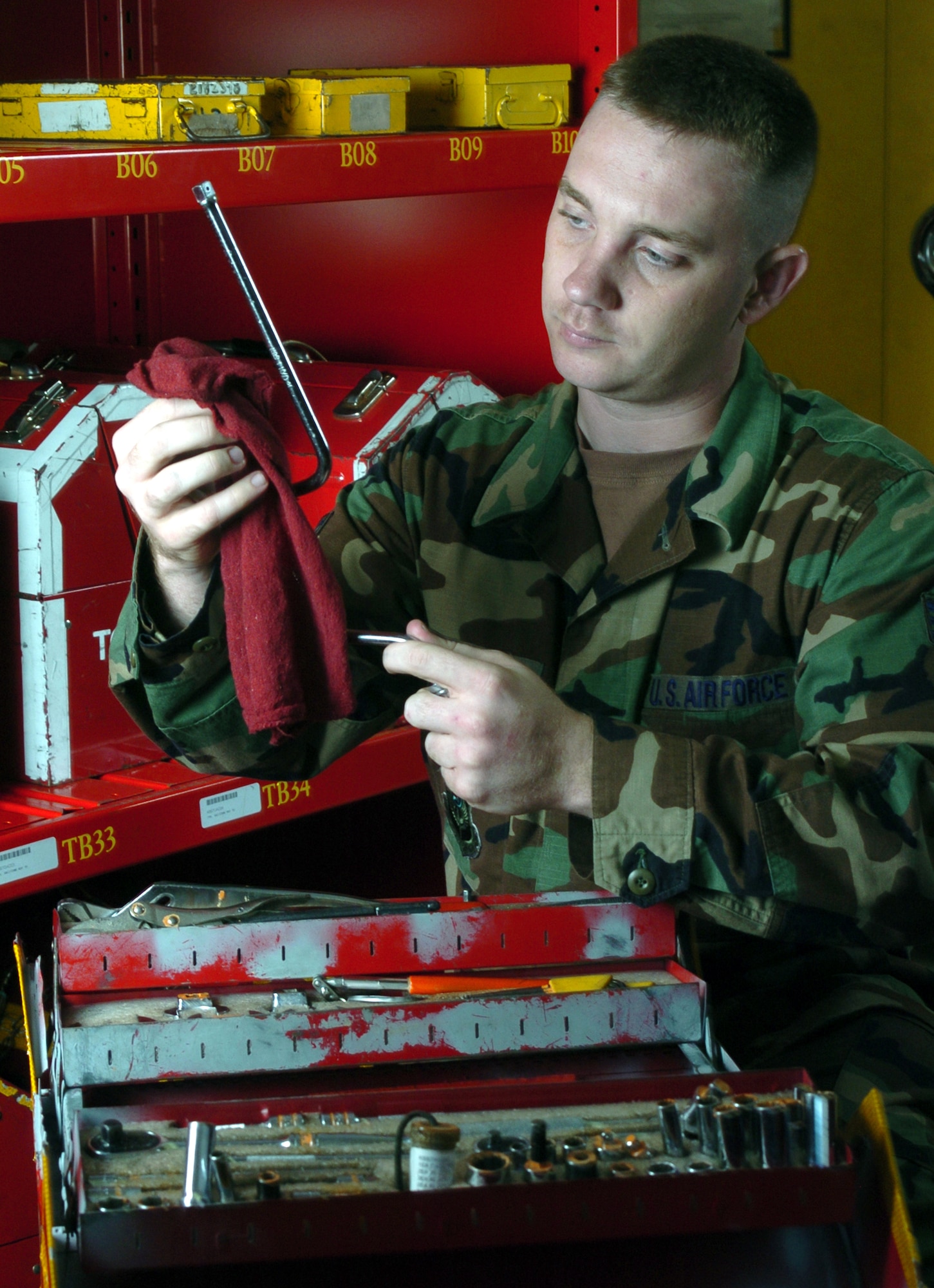 KADENA AIR BASE, Japan -- Senior Airman Chris Runge cleans tools before checking them out at the 353rd Maintenance Squadron's consolidated tool kit section.  The tool kit Airmen handle about 1,600 bench-stock items, about 200 pieces of equipment and 120 hazardous materials for mechanics who maintain the Special Operations MC-130 Combat Talon and Combat Shadow fleet here.  (U.S. Air Force photo by Master Sgt. Val Gempis)