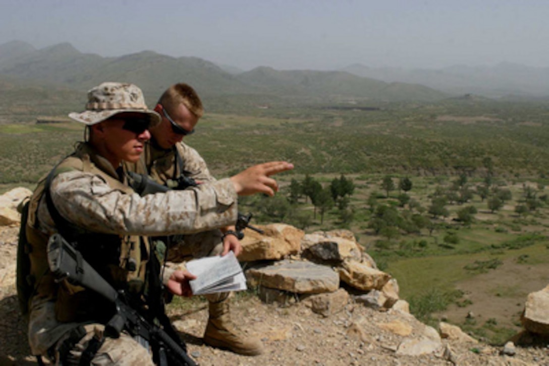 Lt. Menuel Zepeda (left) and Cpl. Austin Hall (right) compare physical features of the terrain with those on a topographical map of the region near the Afghanistan/Pakistan border on Sept. 10, 2004. Zepeda and Hall are with the 3rd Battalion 6th Marine Regiment which is conducting vehicle checkpoints and village assessments while maintaining an offensive presence throughout the region. 