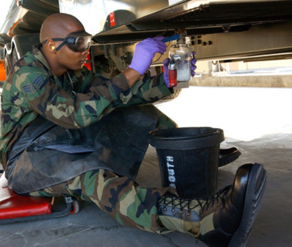 Senior Airman Kelston McDonald takes a sample of JP8 jet fuel.