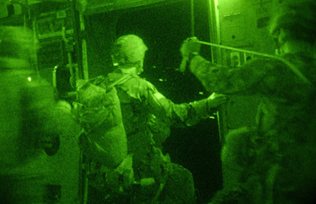 U.S. Army soldiers from the 16th Military Police Brigade prepare to jump from an Air Force C-17 Globemaster III and parachute onto Pope Air Force Base, S.C., on Sept. 15, 2004. This photo was taken using night vision technology. 