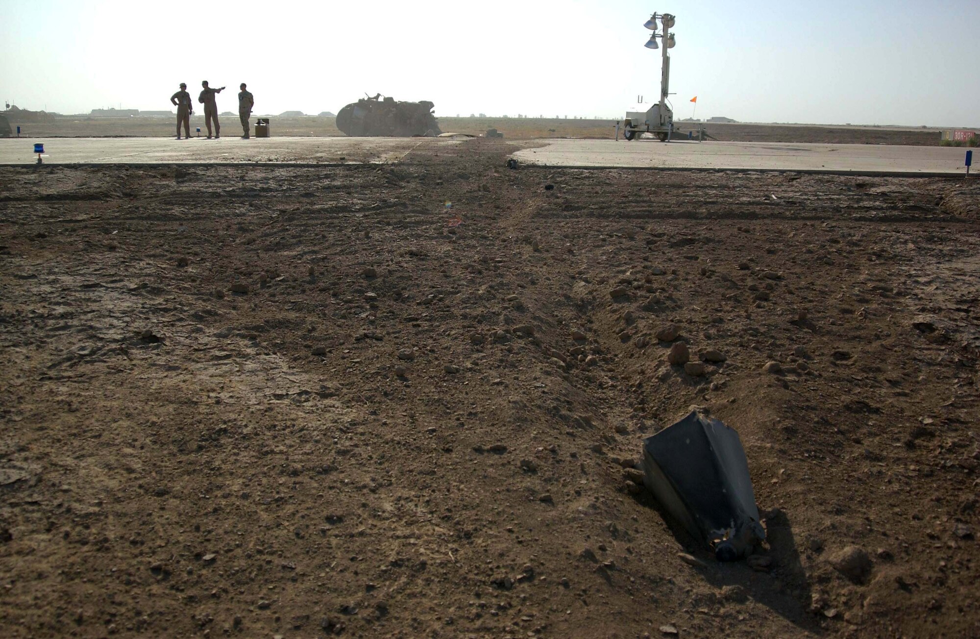 TALLIL AIR BASE, Iraq -- Wreckage from an Army UH-60 Blackhawk crash Sept. 21 is strewn across the flightline here.  All four Soldiers on board were rescued from the helicopter by people of the 407th Air Expeditionary Group and 407th Expeditionary Medical Squadron.  (U.S. Air Force photo by Airman 1st Class Jeff Andrejcik)