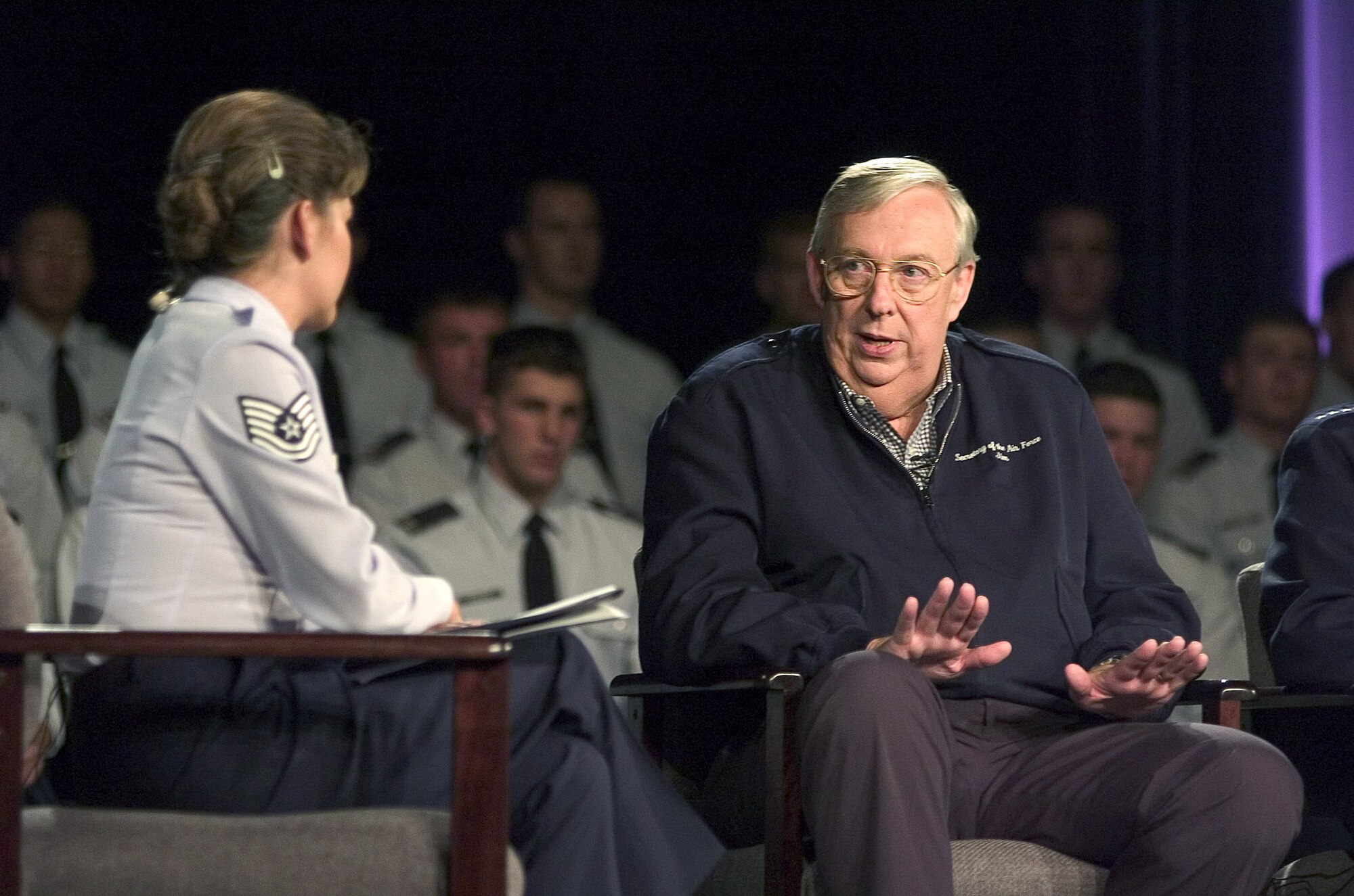 U.S. AIR FORCE ACADEMY, Colo. -- Secretary of the Air Force Dr. James G. Roche answer a question from Tech. Sgt. Pachari Lutke during the town hall meeting here Sept. 27.  Joining the secretary were Air Force Chief of Staff Gen. John P. Jumper and Chief Master Sgt. of the Air Force Gerald R. Murray.  Sergeant Lutke is a broadcaster with Air Force News Service.  The meeting was broadcast live on The Pentagon Channel and American Forces Radio and Television Service stations worldwide.  (U.S. Air Force photo by Charley Starr)