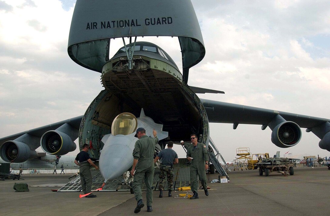 PRETORIA, South Africa -- Airmen of the 174th Fighter Wing from Syracuse, N.Y., load an F-16 Fighting Falcon into a C-5 Galaxy for a flight home to the United States. They participated in the South African Aerospace Exhibition at Waterkloof Air Force Base here.  (U.S. Army photo by Sgt. Matthew Johnson)
