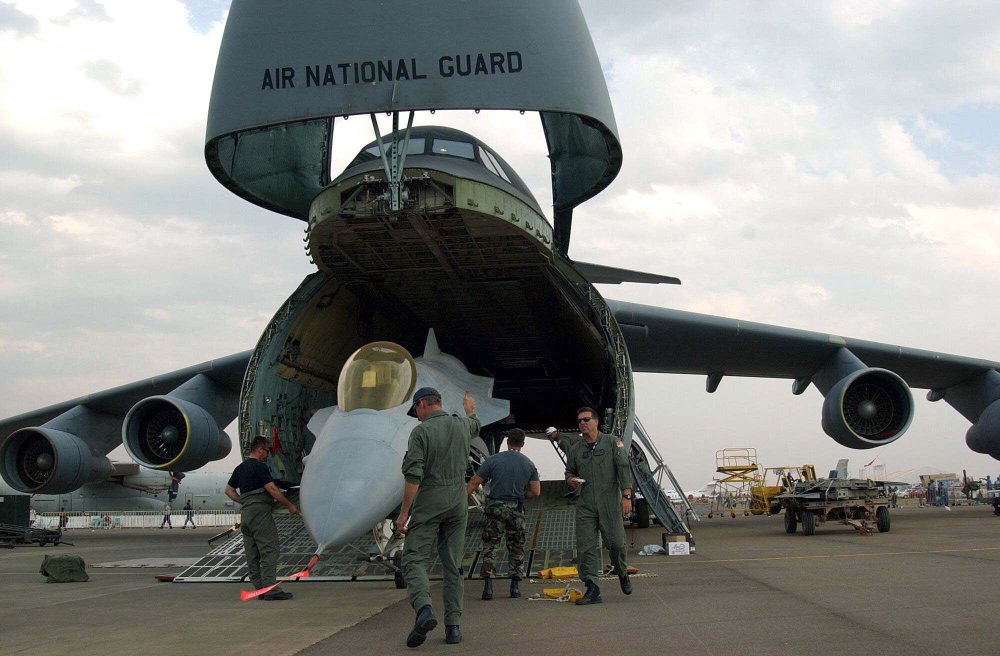 PRETORIA, South Africa -- Airmen of the 174th Fighter Wing from Syracuse, N.Y., load an F-16 Fighting Falcon into a C-5 Galaxy for a flight home to the United States. They participated in the South African Aerospace Exhibition at Waterkloof Air Force Base here.  (U.S. Army photo by Sgt. Matthew Johnson)
