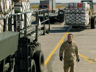 MANAS AIR BASE, Kyrgyz Republic -- Senior Airman Ramon Mestas checks the cargo from a C-17 Globemaster III from McChord Air Force Base, Wash., on Sept. 23.  More than $15 million worth of medicines and medical supplies were flown in.  Airman Mestas is assigned to the 376th Logistics Readiness Squadron here.  (U.S. Air Force photo by Staff Sgt. Chuck Marsh)