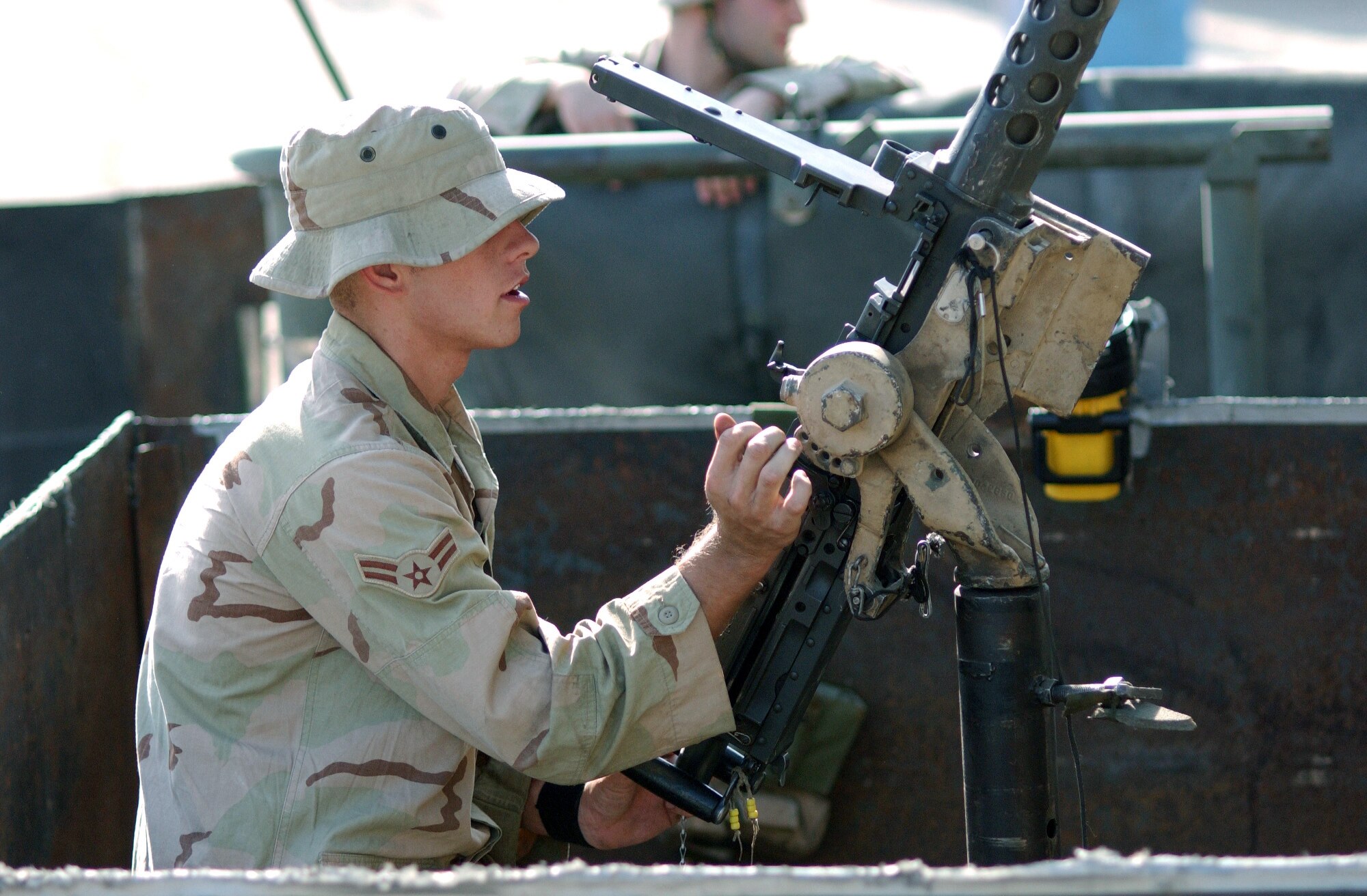 MOSUL, Iraq -- Airman 1st Class Michael Ross readies his .50-caliber machine gun before a convoy escort mission Sept. 22.  Airman Ross is a vehicle operator for Detachment 1 of the 732nd Expeditionary Logistics Readiness Squadron here.  He is deployed from Cannon Air Force Base, N.M.  (U.S. Air Force photo by Staff Sgt. Marc Barnes)