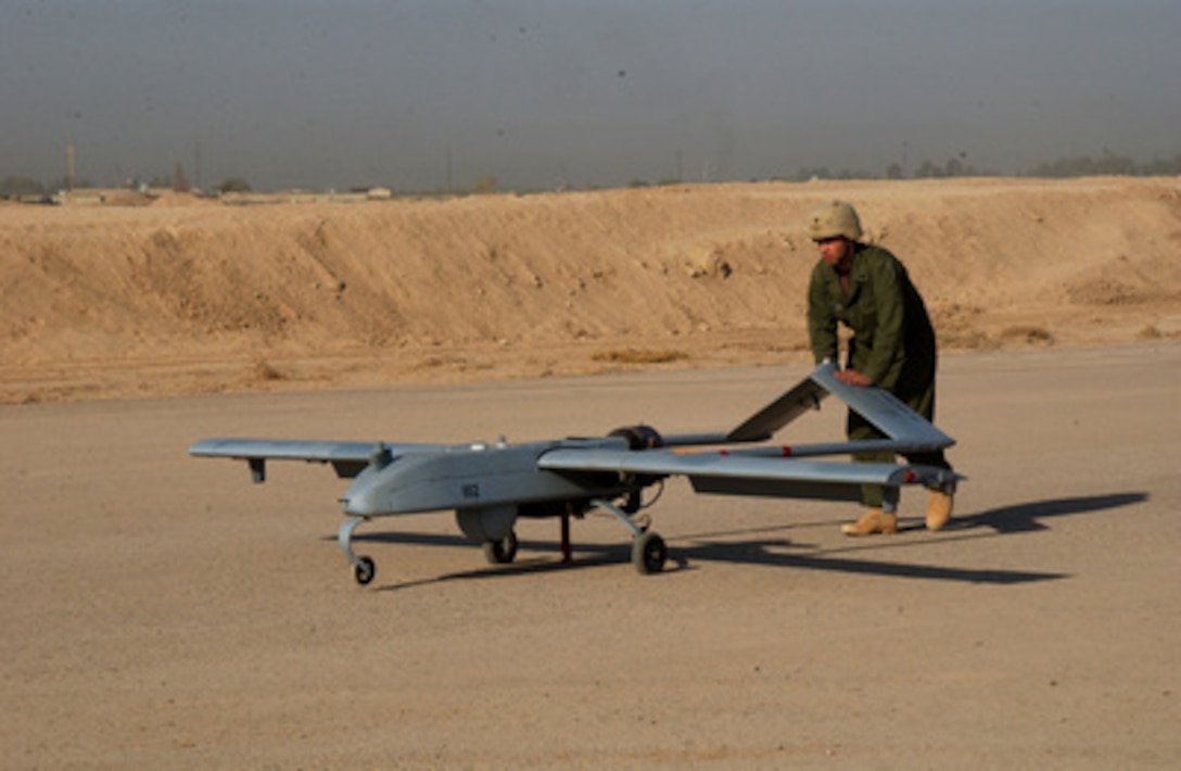 A soldier with the Army's 101st Military Intelligence Battalion pushes a Shadow 200 unmanned aerial vehicle in preparation for launch on a mission over Iraq from Forward Operating Base Warhorse near Baqubah, Iraq, on Sept. 22, 2004. 