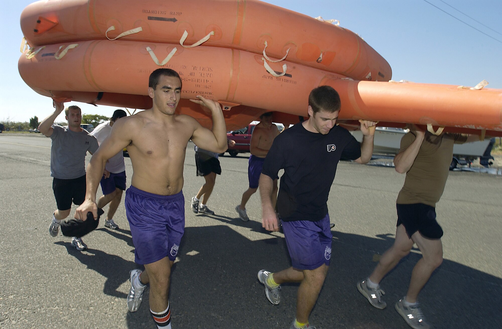 LONG ISLAND BEACH, N.J. -- Players from the Philadelphia Phantoms American Hockey League team and aircrew members from nearby McGuire Air Force Base capped off a day of water-survival training with a two-and-a-half-mile raft race Sept. 23.  The participants carried a life raft over their heads during the race.  The Phantoms participated in the survival exercise as part of their training camp workout.  (U.S. Air Force photo by Kenn Mann)