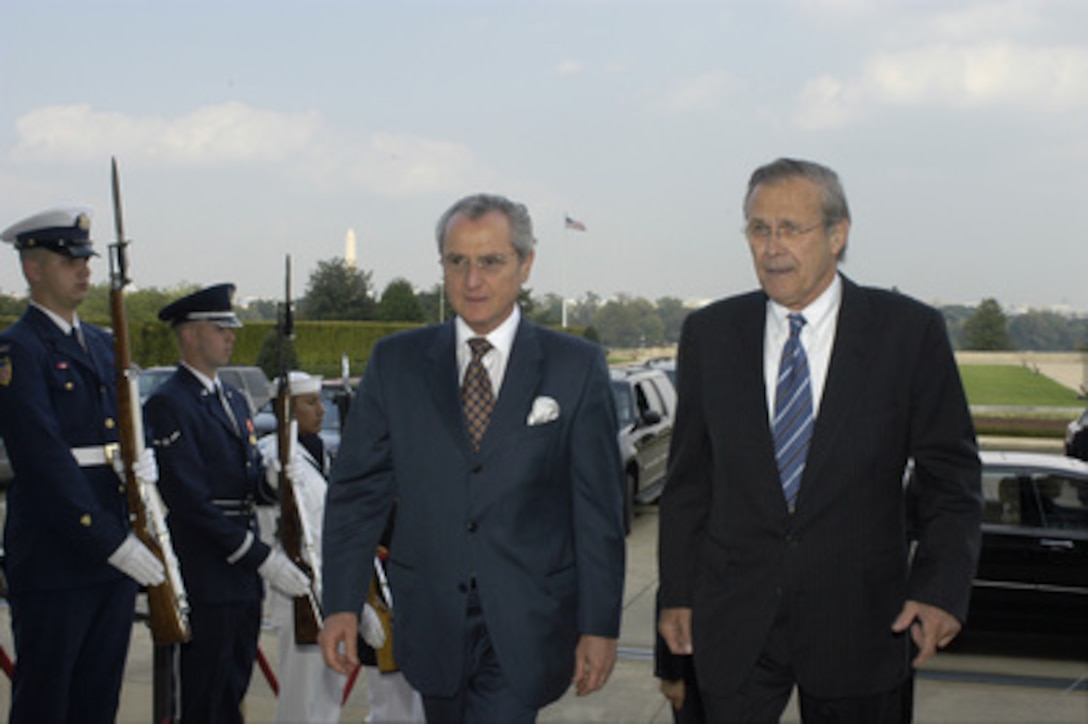Secretary of Defense Donald H. Rumsfeld (right) escorts Colombian Minister of Defense Jorge Alberto Uribe Echavarria through an honor cordon and into the Pentagon on Sept. 30, 2004. Rumsfeld and Echavarria will meet to discuss defense issues of mutual interest. 