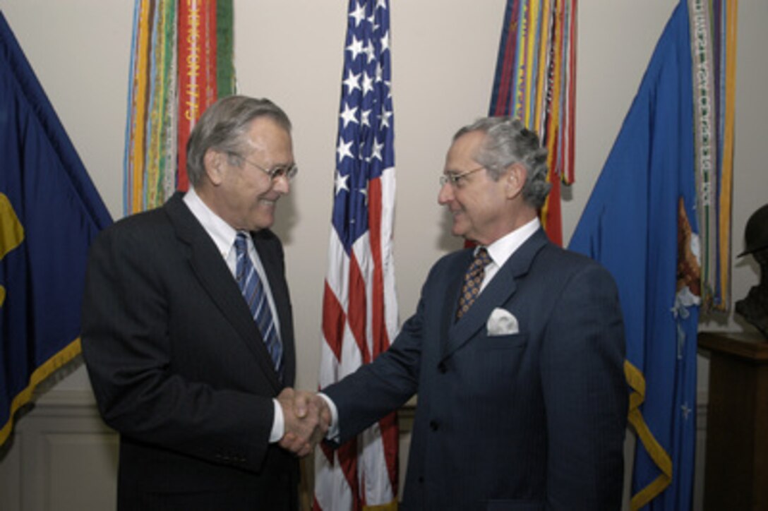 Colombian Minister of Defense Jorge Alberto Uribe Echavarria (right) shakes hands with Secretary of Defense Donald H. Rumsfeld (left) before their meeting in the Pentagon on Sept. 30, 2004. Echavarria and Rumsfeld will meet to discuss defense issues of mutual interest. 