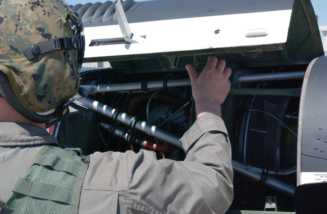 AL ASAD, Iraq -- Staff Sgt. Joseph E. Taylor, Marine Aviation Logistics Squadron 26 (Reinforced) aviation ordnance technician and Smithfield, N.C., native, looks ahead as Marines and airmen push a pallet loaded with bombs off of a C-5 Galaxy cargo plane April 2.  Nineteen airmen with the 332nd Expeditionary Logistics Readiness Squadron are here to help load and unload wide-body aircraft.