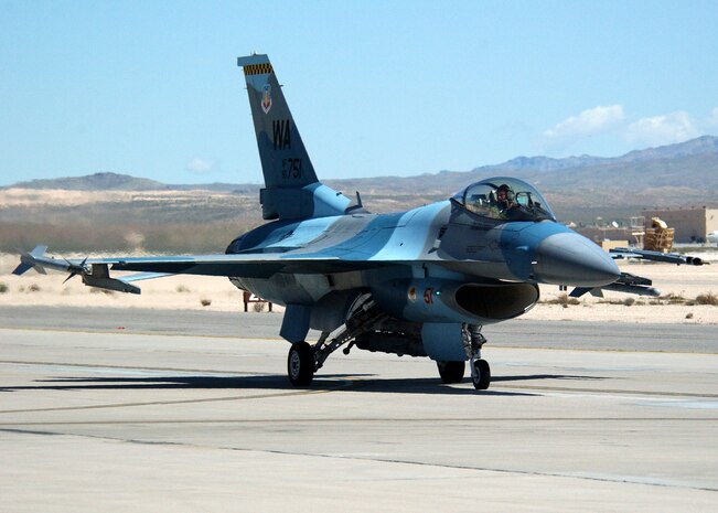 NELLIS AIR FORCE BASE, Nev. -- An aggressor pilot makes his way to the runway for a Joint Red Flag mission.  The F-16 Fighting Falcons flown by 64th Aggressor Squadron pilots are used to replicate the air-combat tactics of potential threats and are painted to resemble enemy aircraft.  (U.S. Air Force photo by Airman 1st Class Trina Flannagan)
