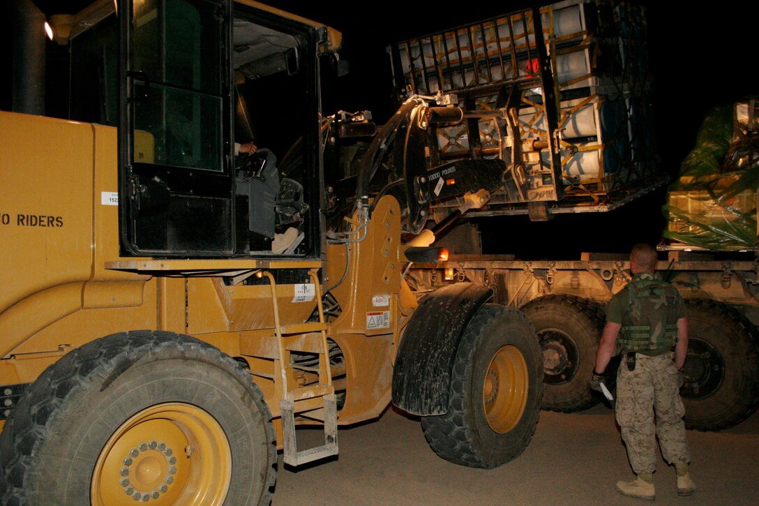 AL ASAD, Iraq -- Airman 1st Class Kristian Dela Cruz, an air cargo specialist from Sunnyvale, Calif., loads ordnance onto a logistics vehicle after offloading a C-5 Galaxy cargo plane April 2.  A detachment of 19 airmen from the 332nd Expeditionary Logistics Readiness Squadron is here helping units in western Iraq accomplish their mission in support of Operation Iraqi Freedom.
