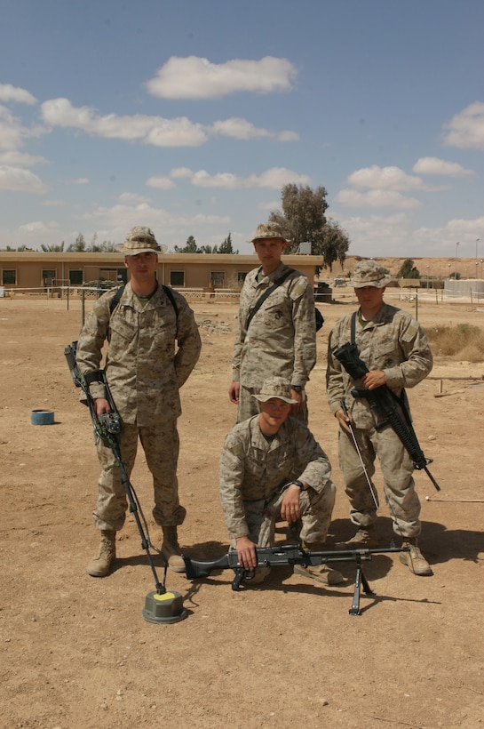 AL ASAD, Iraq - One of the A Company, 6th Engineering Support Battalion, augmenting 8th ESB and supporting Combat Logistics Battalion -2, 2d Force Service Support Group (Forward), sapper teams pose for a photograph after demonstrating proper mine clearing techniques. From left, clockwise: Cpl. Nathan Winegardner, a Vancouver, Wash., native; Sgt. Rick Noble, a Corvallis, Ore., native; Pfc. Andrew Wollam, a Springfield, Ore., native; and Lance Cpl. Draper Robinson, a Longview, Wash. Native. These Marines specialize in the discovery and destruction of mines. Sapper teams attach to every convoy CLB-2 dispatches as part of the battalion's security and force protection measures to mitigate the mine threat along convoy routes throughout their area of operations. (Photo by Cpl. John E. Lawson Jr.)  -30-