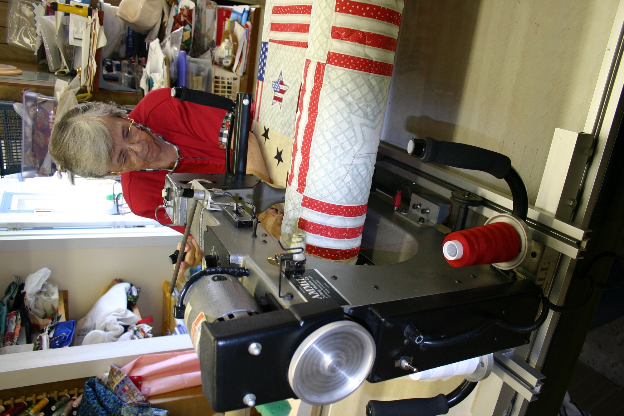 LYTLE, Texas -- Louis Smith adds a pattern to a lap quilt for a wounded servicemember.  (U.S. Air Force photo)