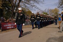 Maj. Mike J. Corrado leads a platoon of 32 Marines Nov. 10, to the Leavenworth, Kan., home of Staff Sgt. Daniel Gilyeat, a wounded Iraqi War veteran who served with the 24th Marine Regiment. The platoon served as part of a filmed ceremony for Gilyeat's feature on the hit show "Extreme Makeover: Home Edition," where his home was remodeled free of charge. The platoon was a mere fraction of the community there to honor Gilyeat.